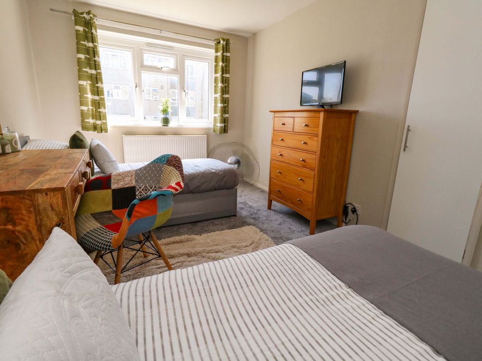 A bedroom with a bed and television at Lily's Pad in Weston, Portland
