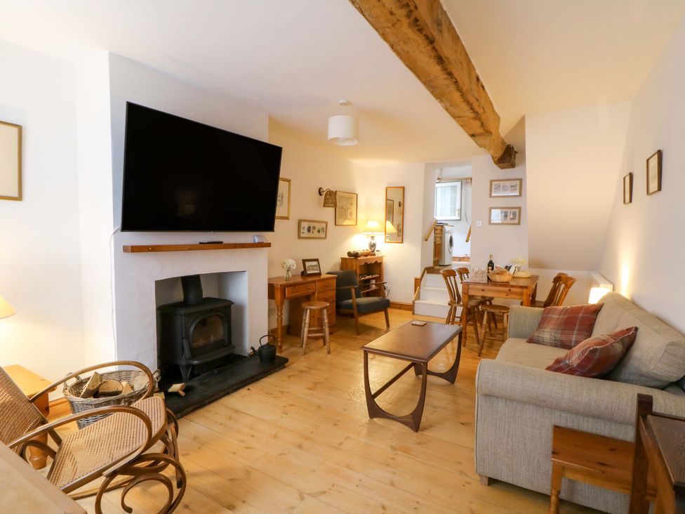 A living room with a fireplace and a television at No.23 Queen St in Aberystwyth