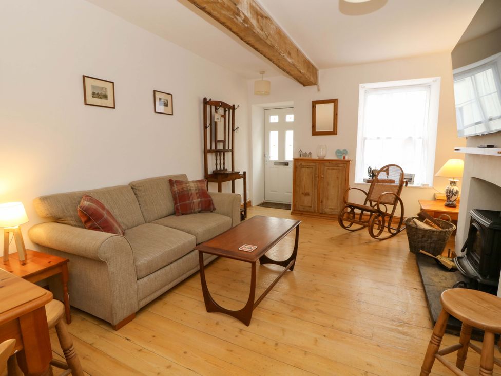 A living room with a sofa and coffee table at No.23 Queen St in Aberystwyth