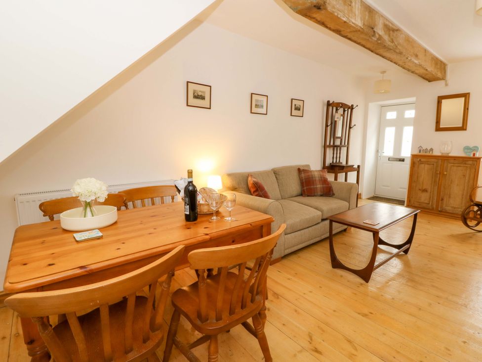 A living room with a sofa and dining table at No.23 Queen St Aberystwyth
