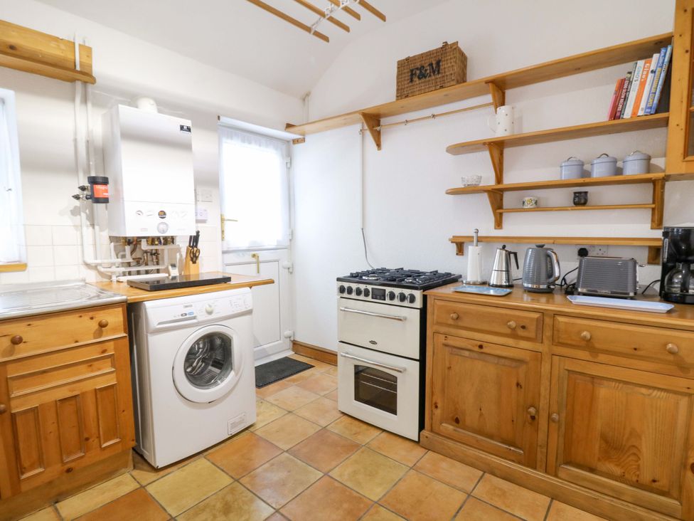A kitchen with a washing machine and cooker at No.23 Queen St Aberystwyth