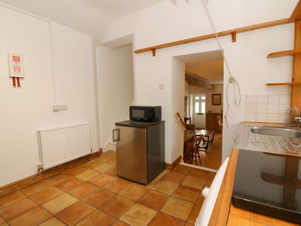 A kitchen with a refrigerator and microwave at No.23 Queen St Aberystwyth