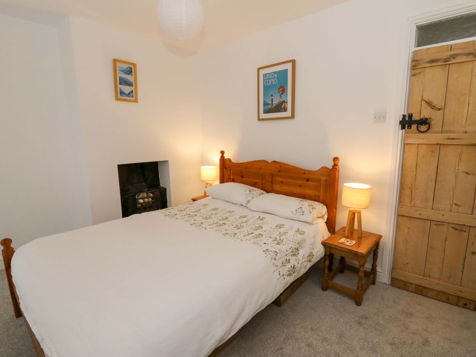 A bedroom with a bed and nightstand at No.23 Queen St Aberystwyth
