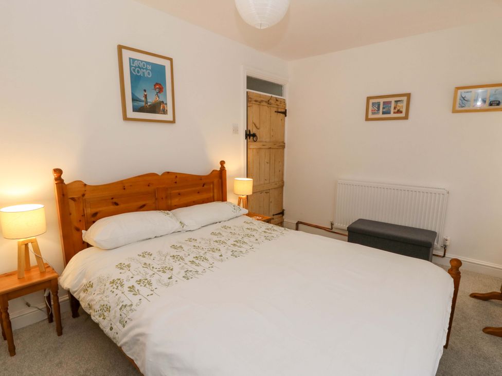 A bedroom with a bed and nightstand at No.23 Queen St in Aberystwyth