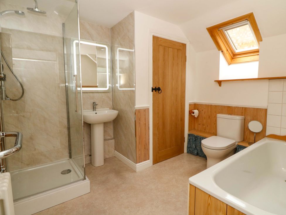A bathroom with a shower, toilet, sink, and bathtub at No.23 Queen St in Aberystwyth