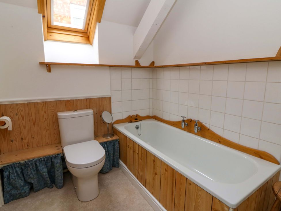 A bathroom with a bathtub and toilet at No.23 Queen St in Aberystwyth