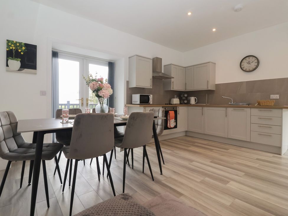 A kitchen with a table and chairs at Birch Cottage in Scarborough