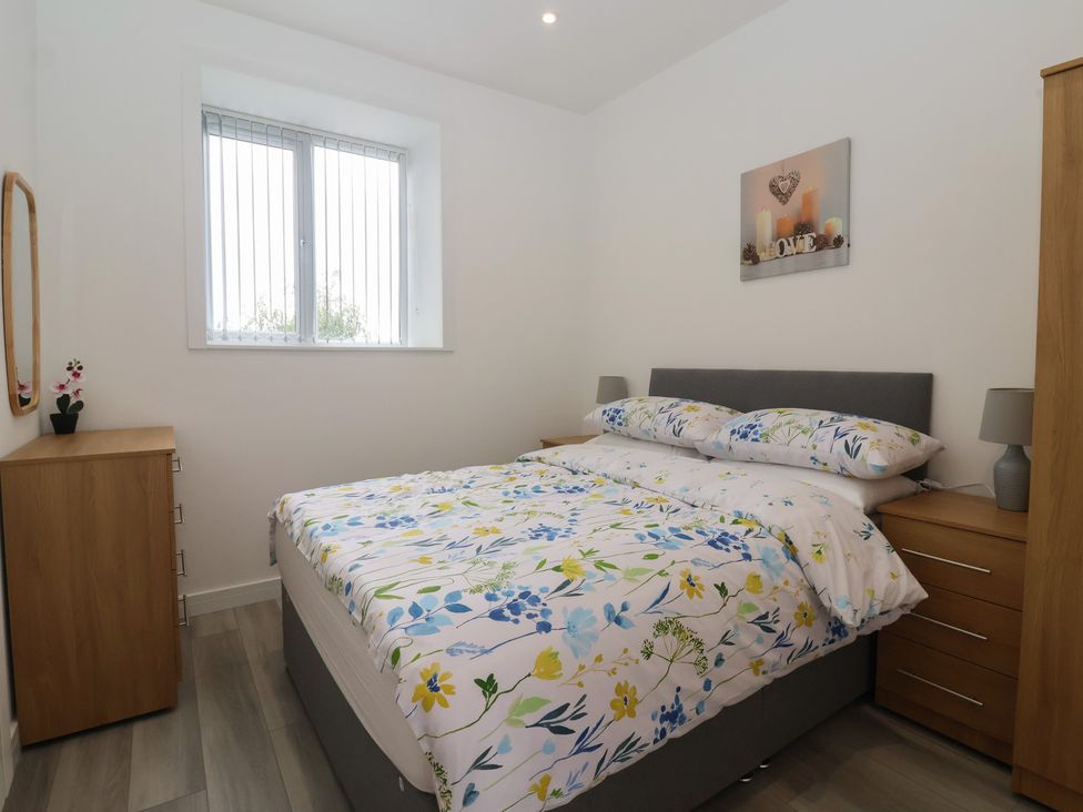 A bedroom with a bed and furniture at Birch Cottage in Scarborough