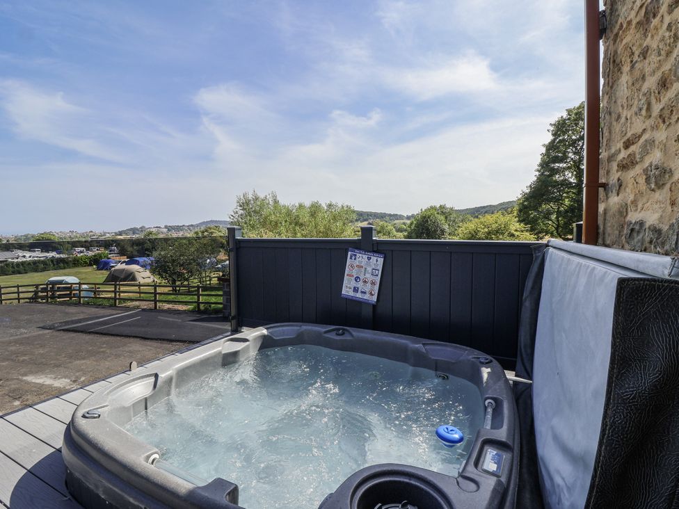 A hot tub with a view in an outdoor area at Birch Cottage in Scarborough