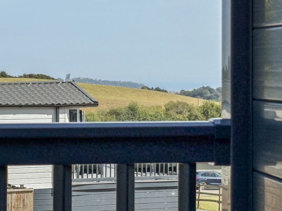 A view of a house and fields from a balcony at Birch Cottage Scarborough