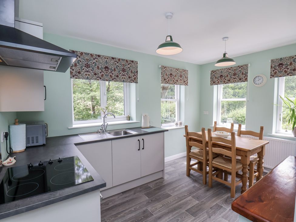 A kitchen with a countertop and dining table at Whinstone Cottage Esk Valley near Grosmont