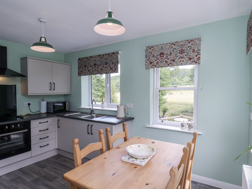 A kitchen with sink and appliances at Whinstone Cottage in Esk Valley near Grosmont