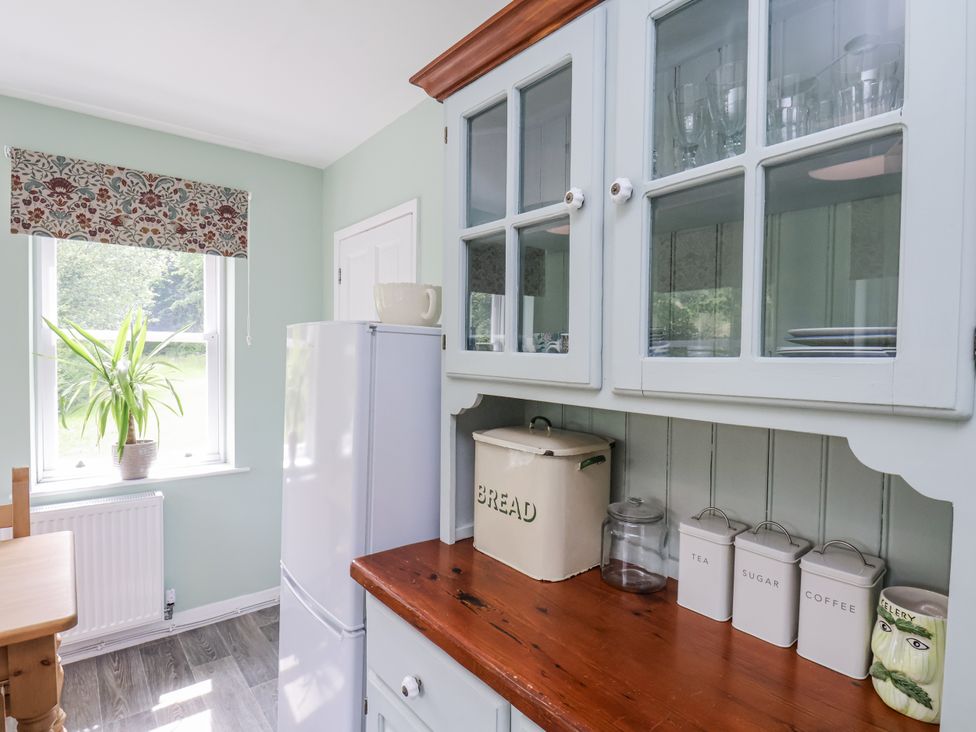 A kitchen with a refrigerator and canisters at Whinstone Cottage Esk Valley near Grosmont