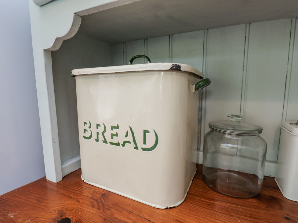 A bread bin and glass jar on a countertop at Whinstone Cottage Esk Valley near Grosmont