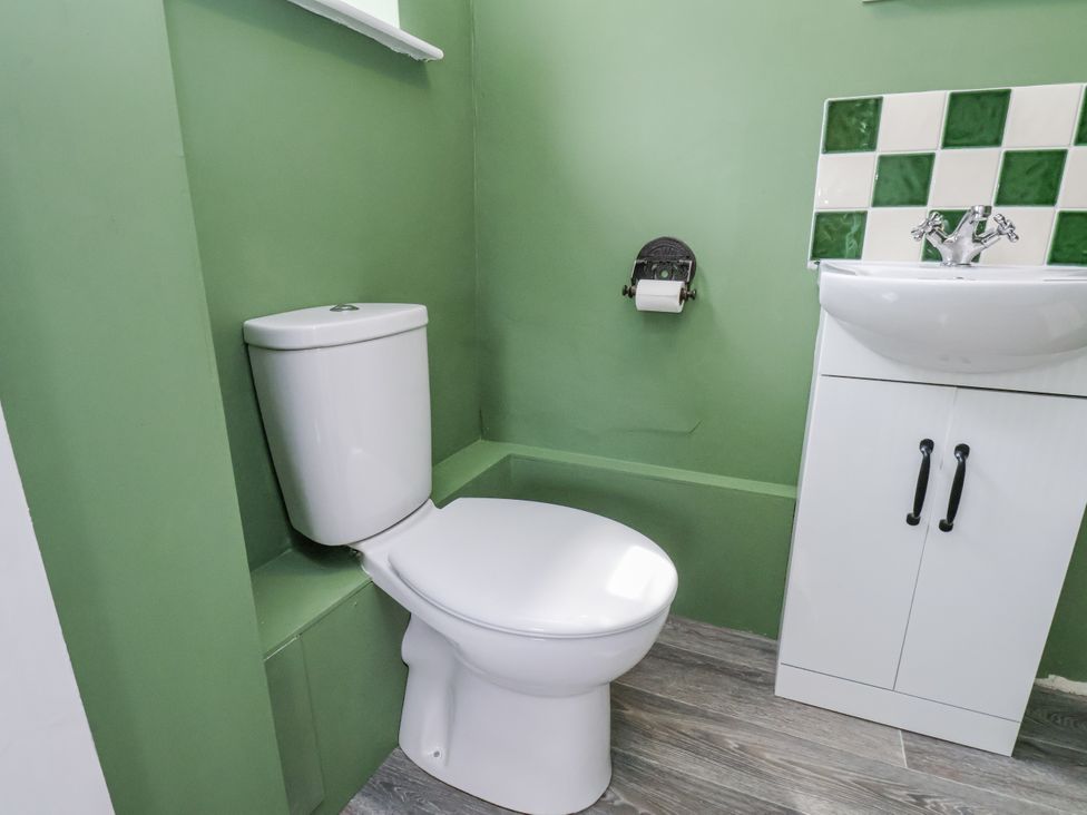 A bathroom featuring a toilet and sink at Whinstone Cottage Esk Valley near Grosmont
