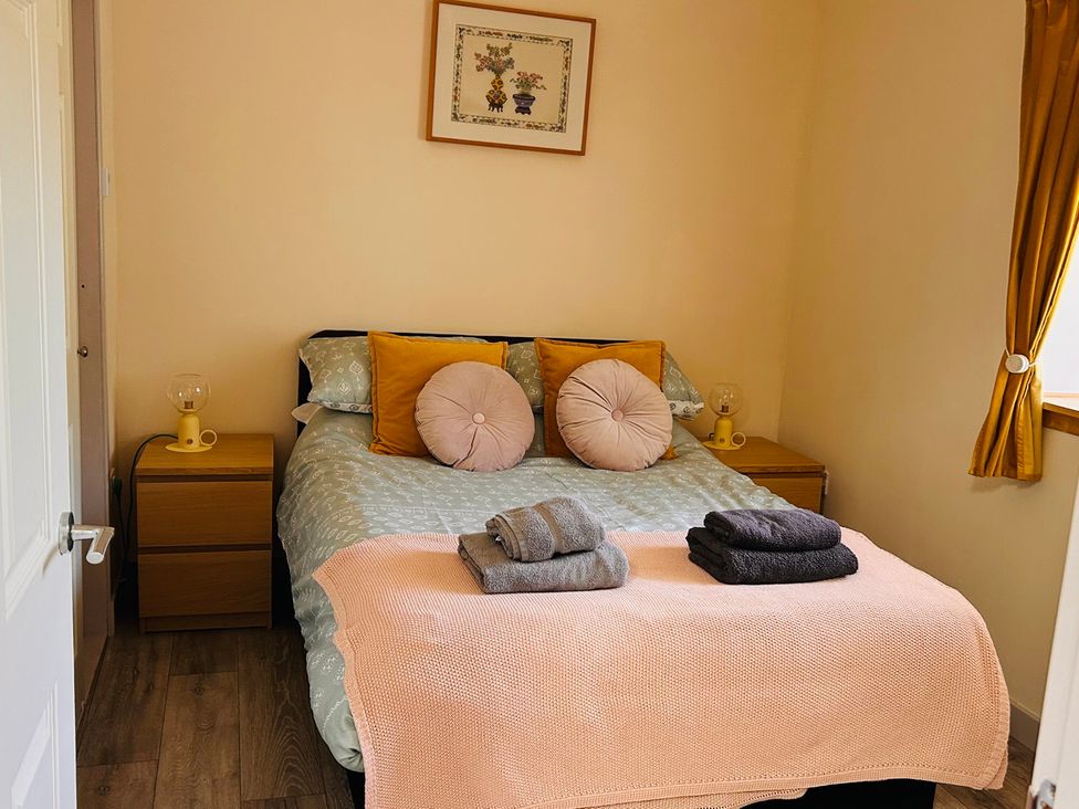 A bedroom with a bed and bedside tables at Bathach Beag, Balvicar, Isle Of Seil