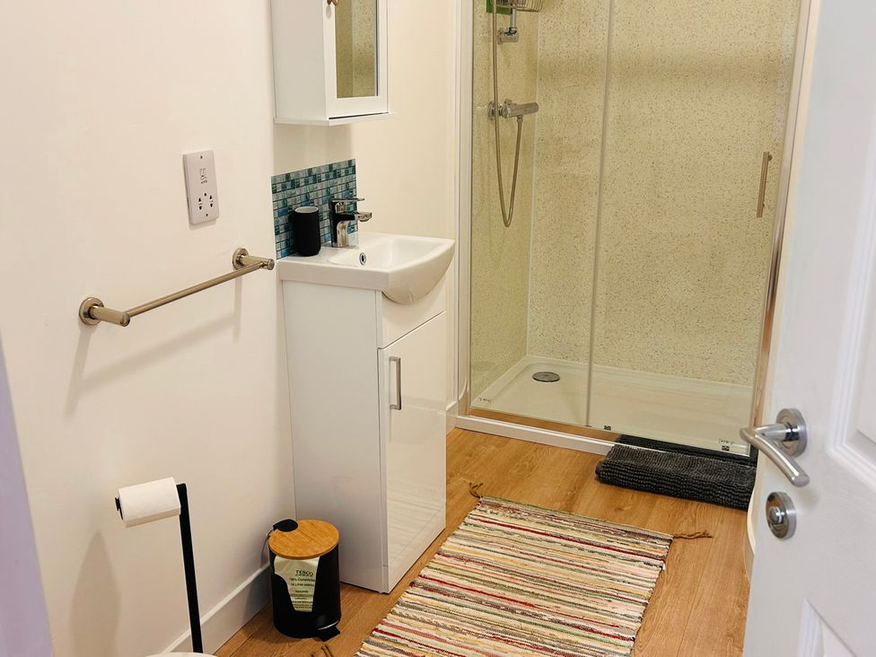A bathroom with a shower and wash basin at Bathach Beag Balvicar, Isle Of Seil