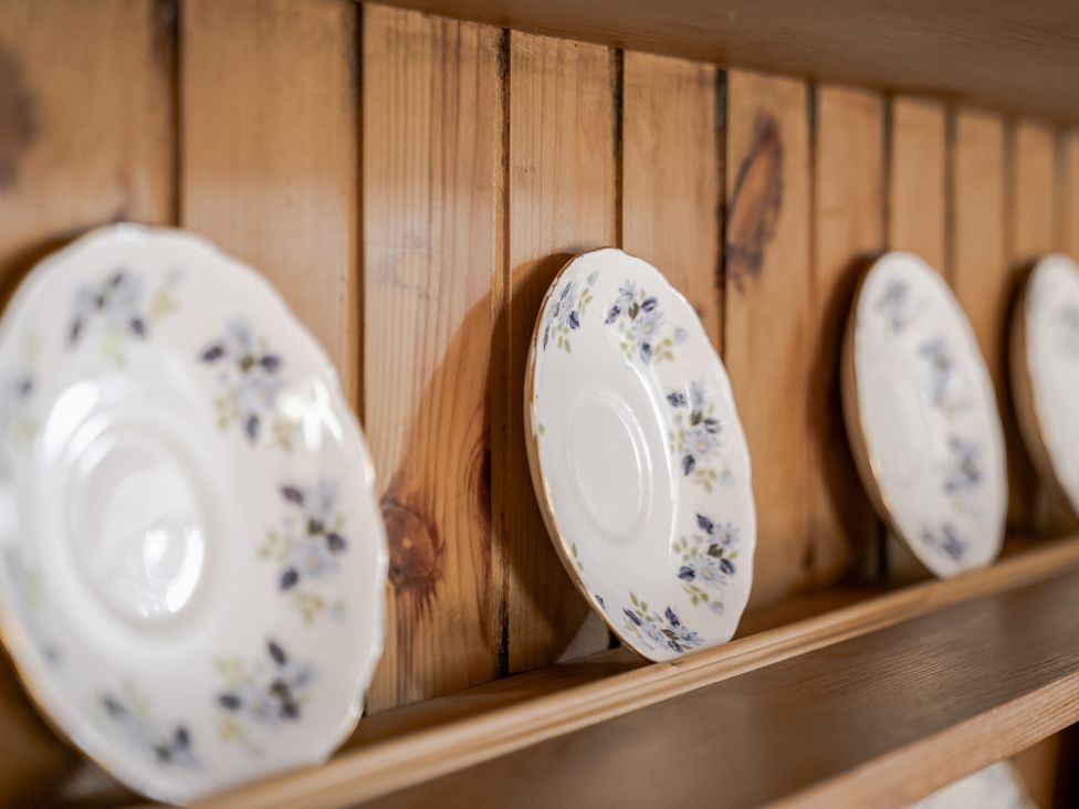 A shelf with decorative plates on display at Cove Cottage in Llangrannog