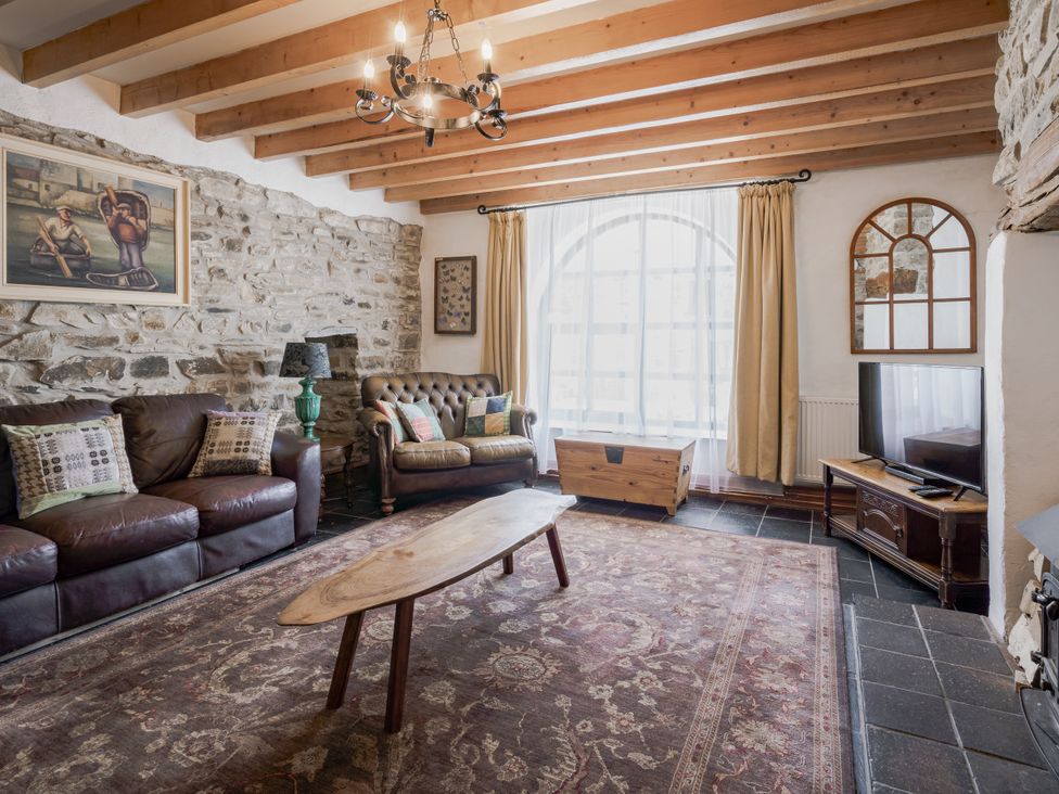 A living room with a coffee table and sofa at Coach House in Llangrannog