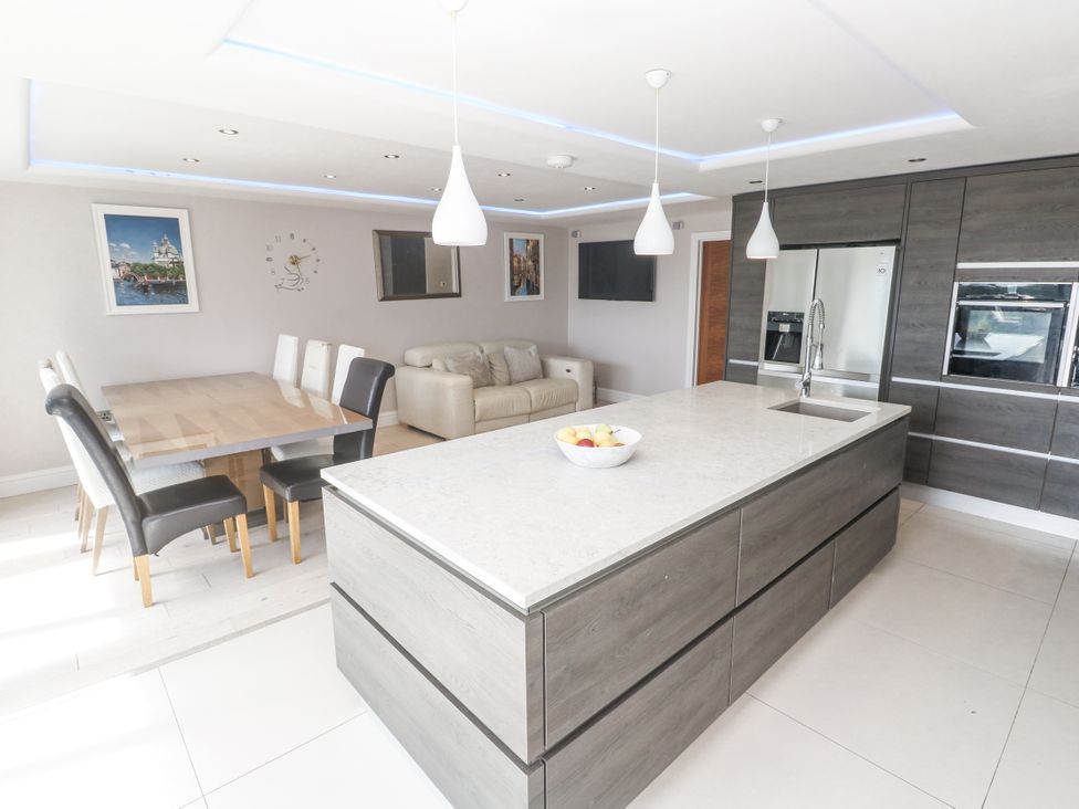 A kitchen with an island and dining area at Treliance in Truro