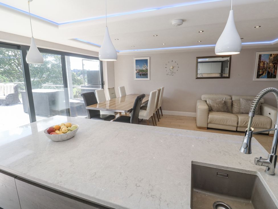 A kitchen with a dining table and chairs at Treliance in Truro