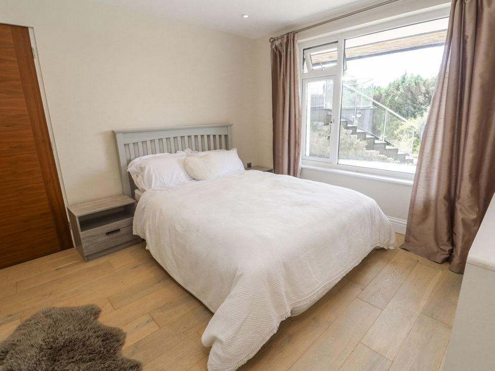 A bedroom with a bed and nightstand at Treliance in Truro
