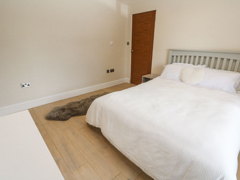 A bedroom with a bed and door at Treliance in Truro