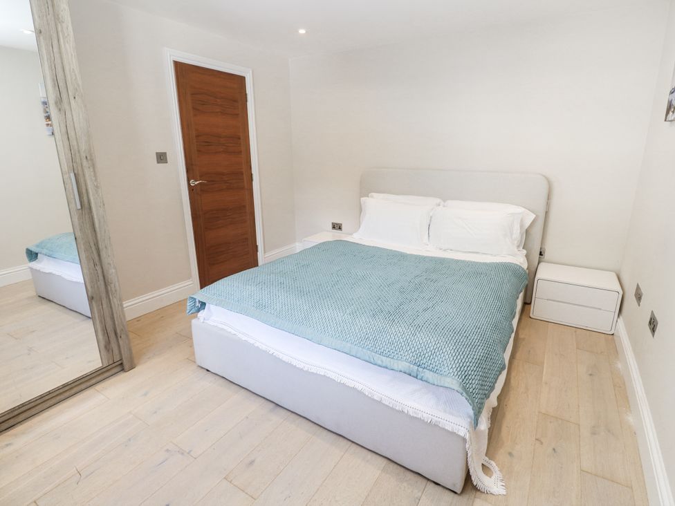 A bedroom with a bed and bedside table at Treliance in Truro