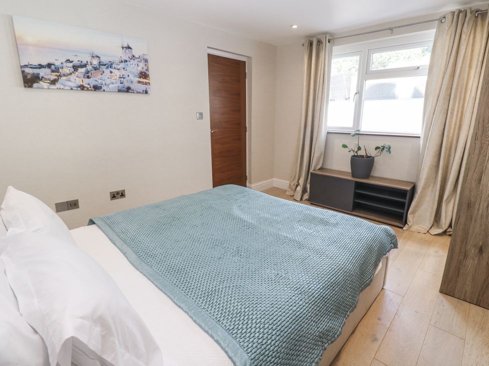 A bedroom with a bed and window at Treliance in Truro
