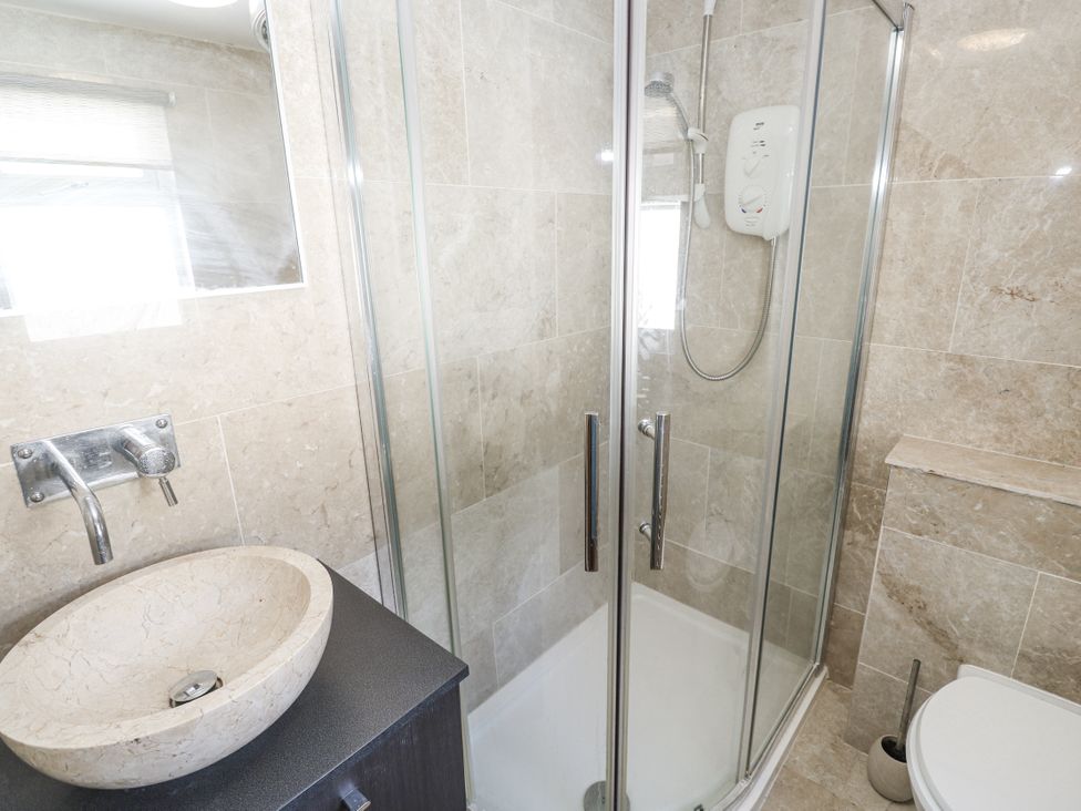 A bathroom with a shower and a sink at Treliance in Truro