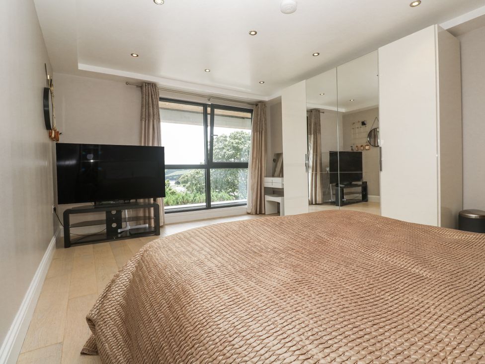 A bedroom with a bed and television at Treliance in Truro