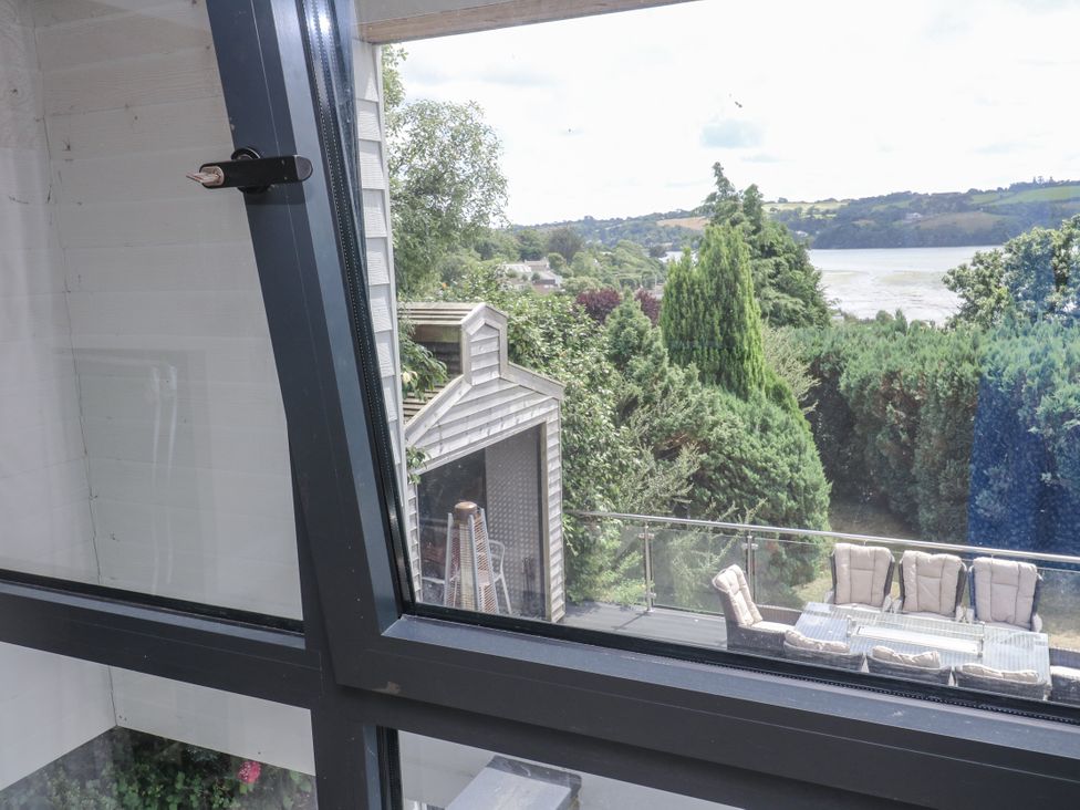 A view from a window showing a garden and river at Treliance in Truro