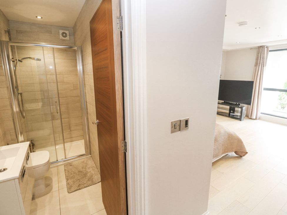 A bathroom with shower, toilet, and sink at Treliance in Truro