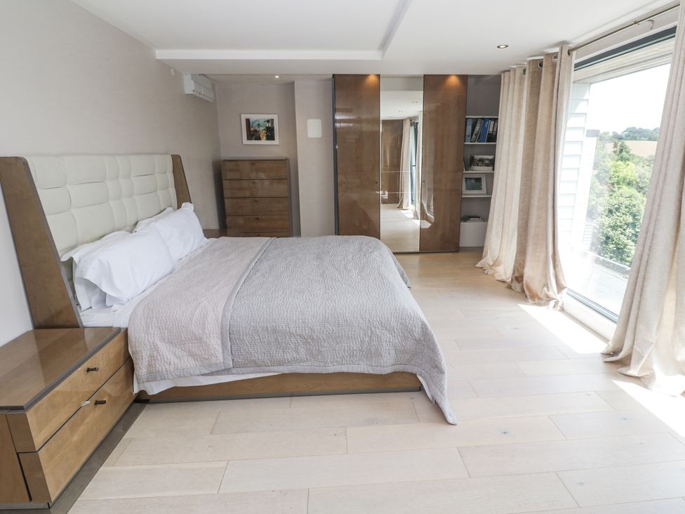 A bedroom with a bed and dresser at Treliance in Truro