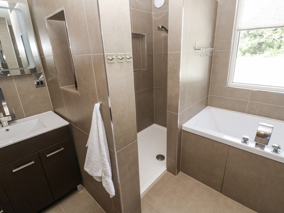 A bathroom with a sink, shower, and bathtub at Treliance in Truro