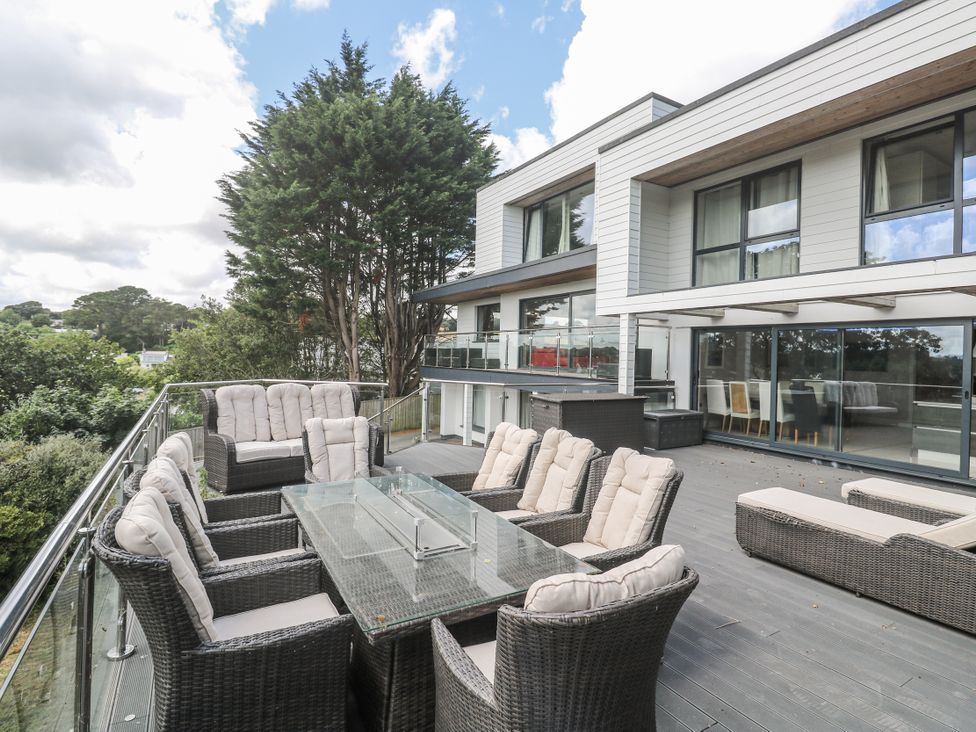 An outdoor seating area with a table and chairs at Treliance in Truro