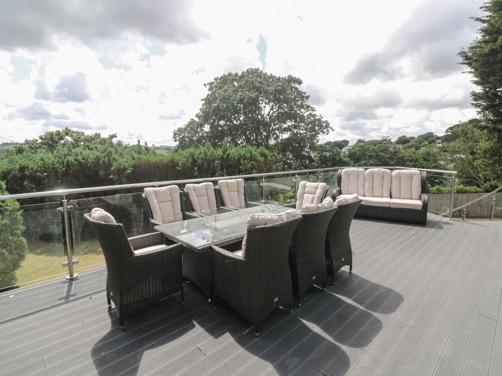 An outdoor seating area with a table and chairs at Treliance in Truro