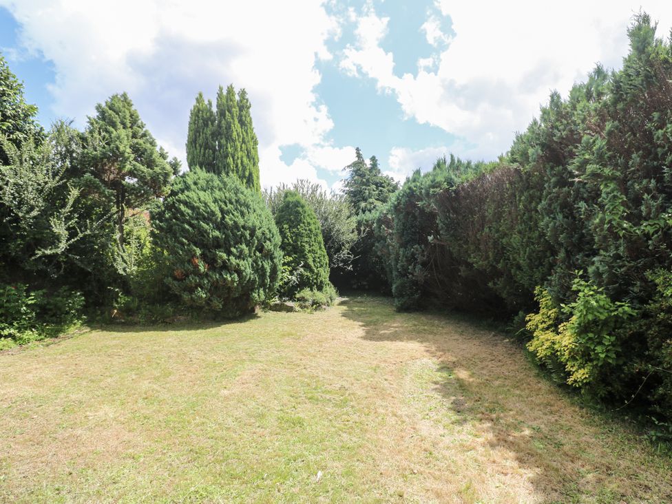 A garden area with trees and grass at Treliance in Truro