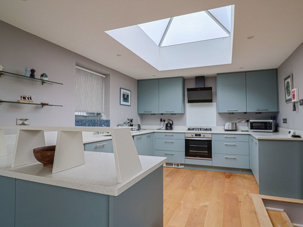 A kitchen with skylight and modern appliances at The Well House in Lyme Regis