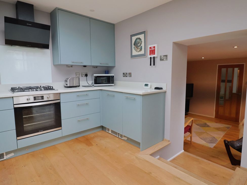 A kitchen with appliances and cabinets at The Well House in Lyme Regis
