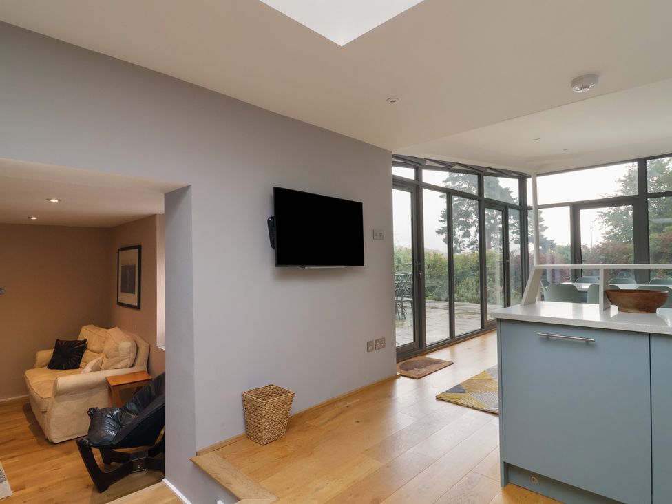A living room with a sofa and television at The Well House in Lyme Regis