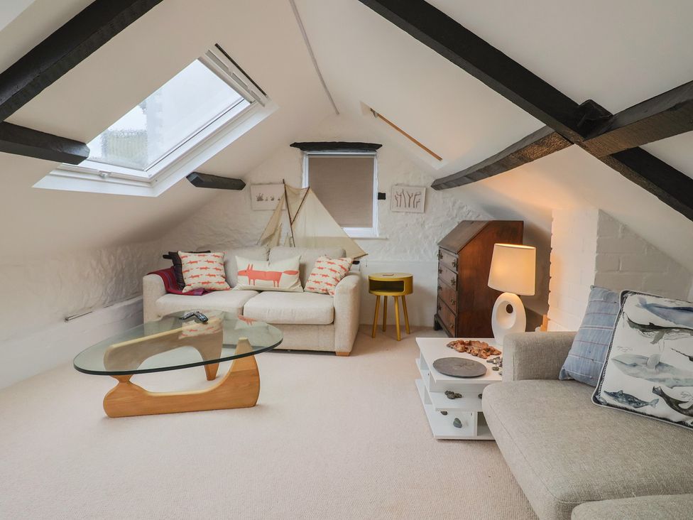A living room with a sofa and a coffee table at The Well House in Lyme Regis