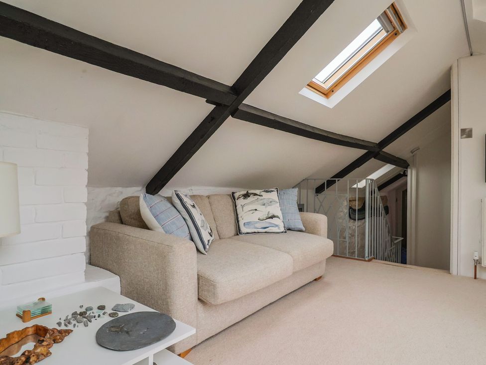 A snug with a sofa and coffee table at The Well House in Lyme Regis