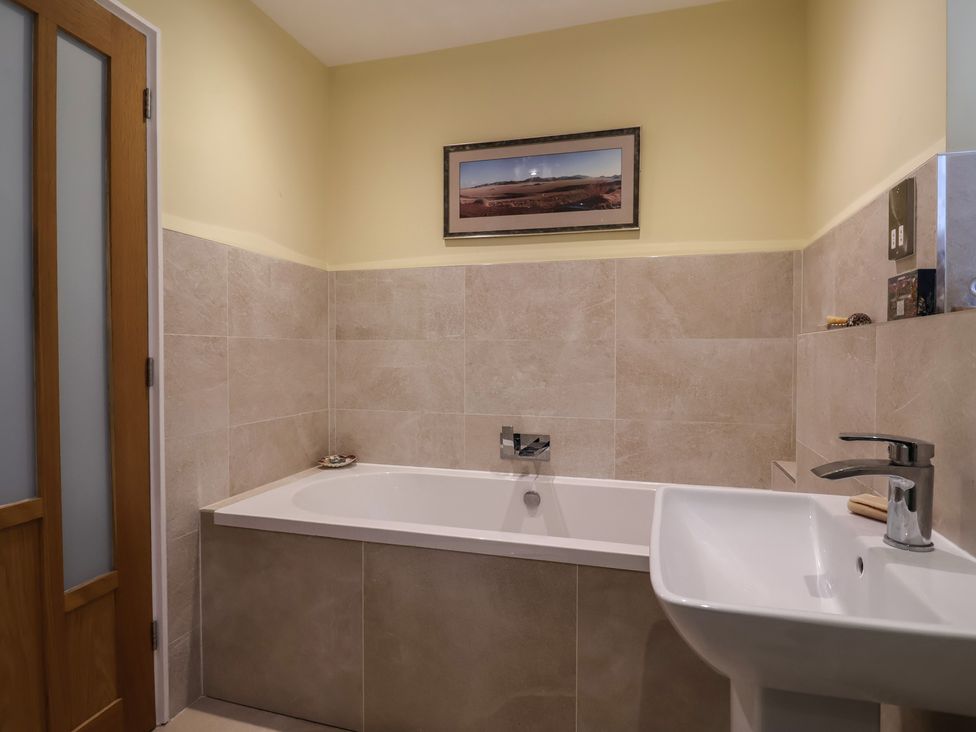 A bathroom with a bathtub and sink at The Well House in Lyme Regis