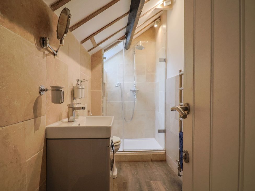 A bathroom with a shower and sink at The Well House in Lyme Regis