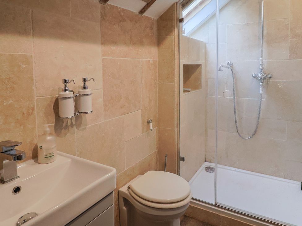 A bathroom with a sink and shower at The Well House Lyme Regis