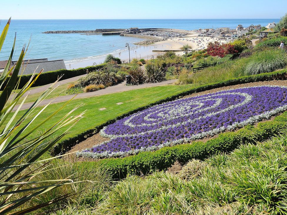 A garden with flowers and view of the sea at The Well House in Lyme Regis