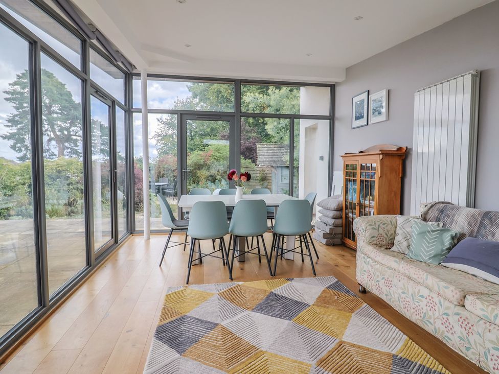 A dining room with a table and chairs at The Well House in Lyme Regis