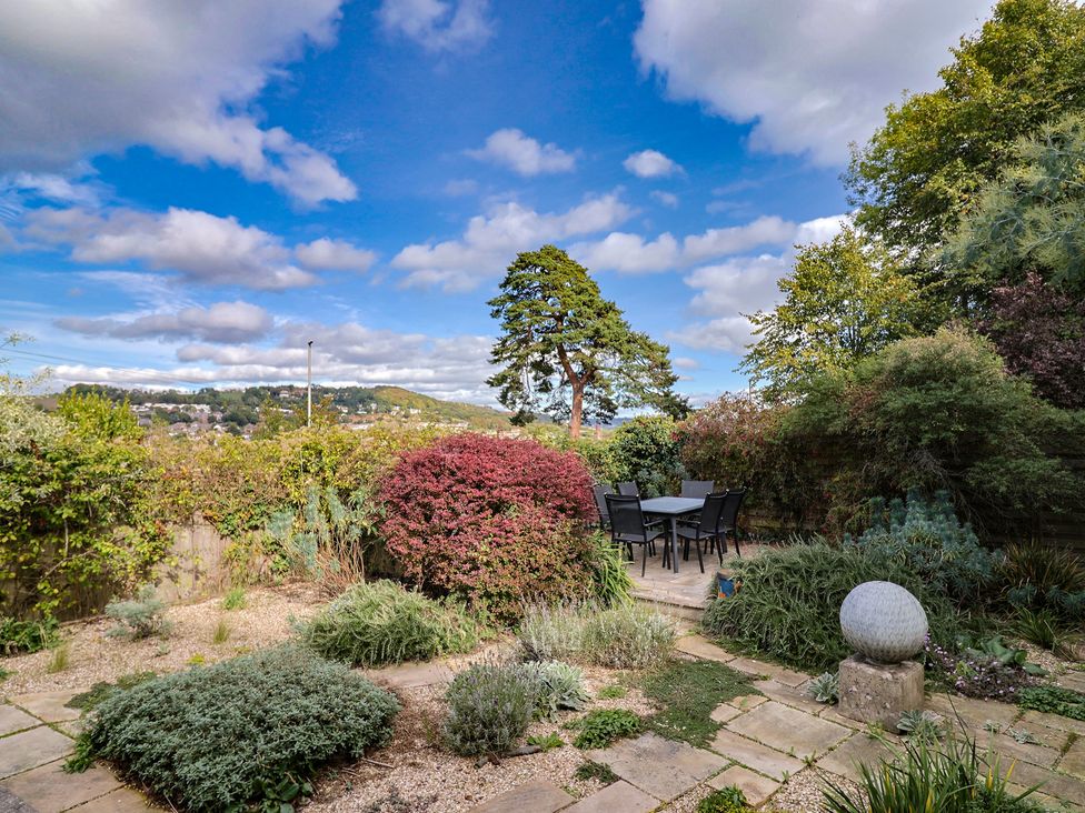 A garden with table and chairs at The Well House in Lyme Regis