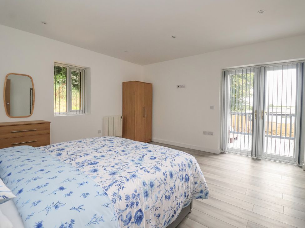 A bedroom with a bed and wardrobe at Castle View in Scarborough